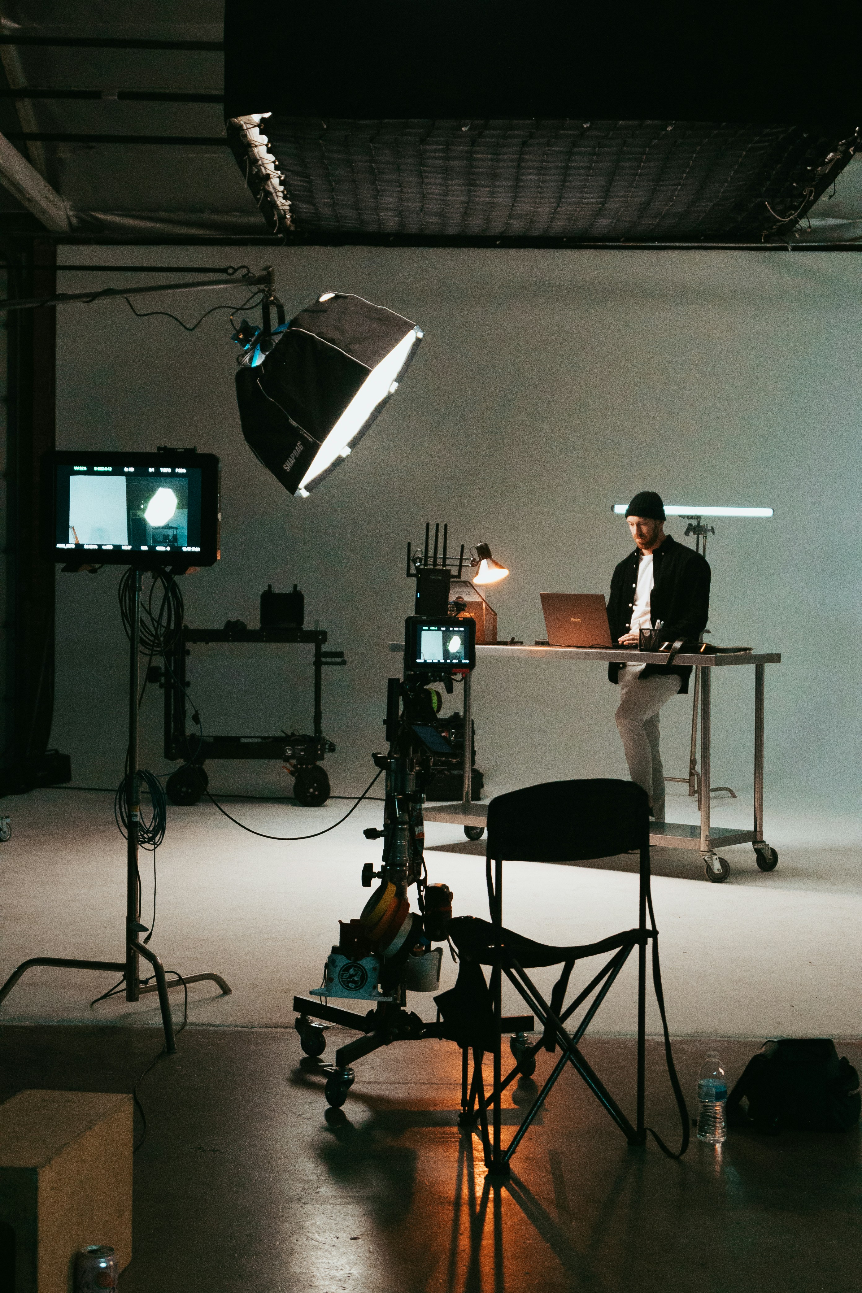 a man sitting at a desk in front of a laptop computer