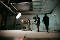a man and a woman standing in front of a camera