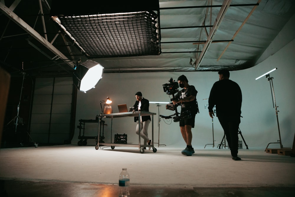 a man and a woman standing in front of a camera