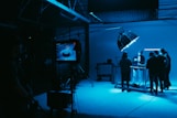 a group of people standing in a dark room
