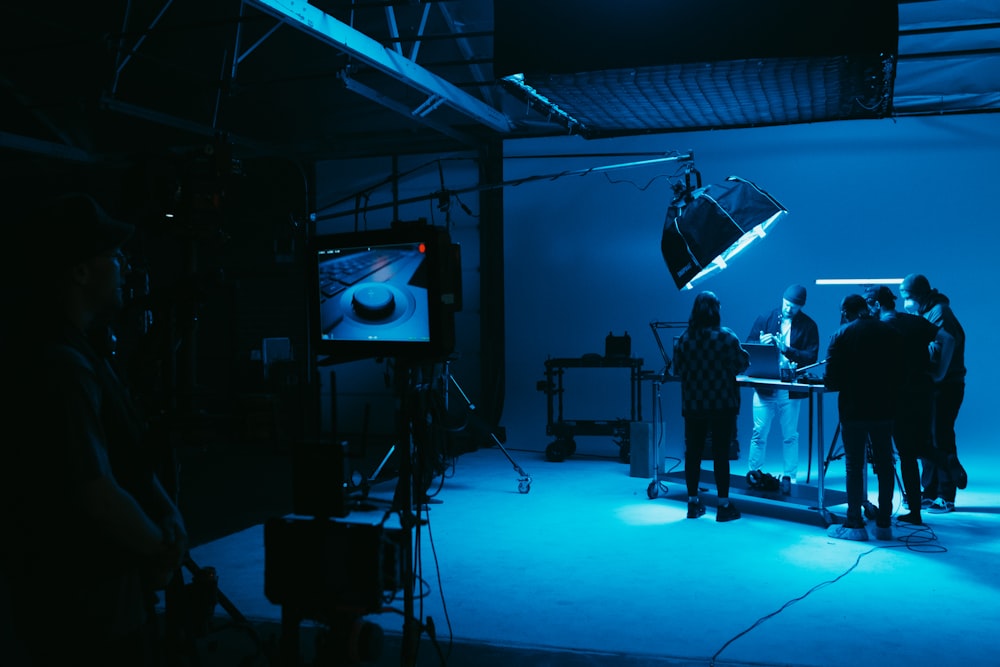 a group of people standing in a dark room