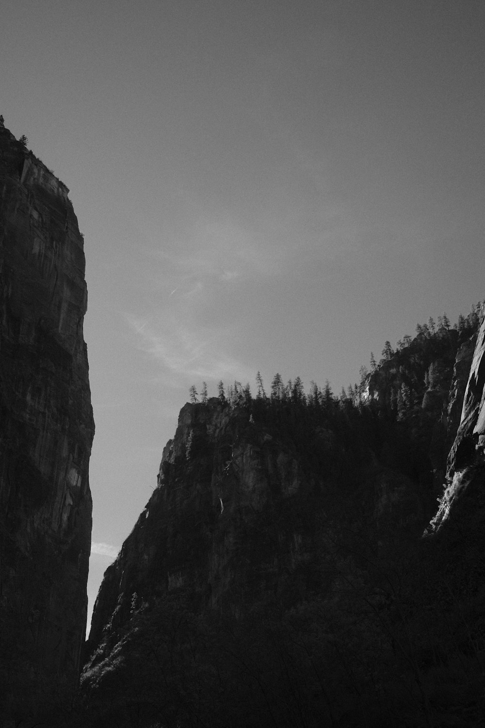 a black and white photo of a mountain side