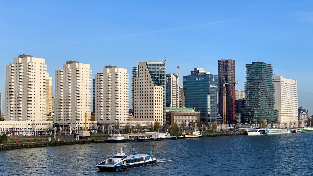 a boat traveling down a river next to tall buildings