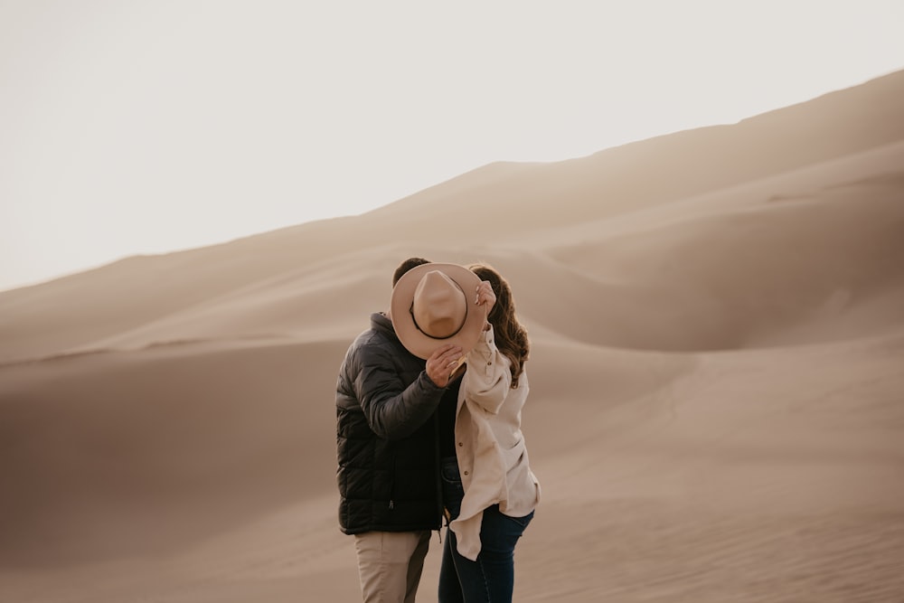 a man and a woman standing in the desert