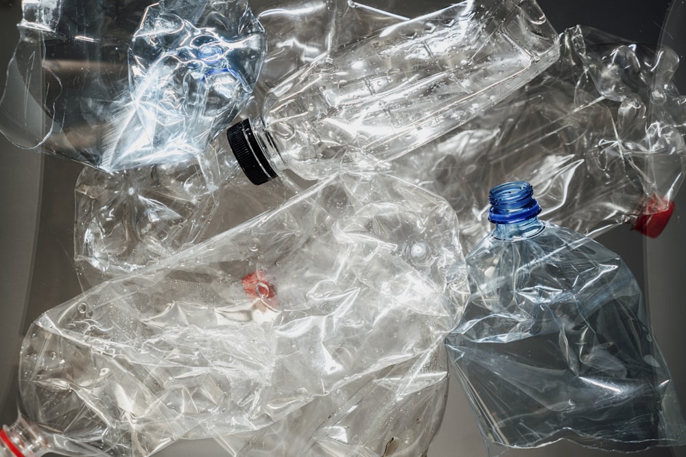 a pile of plastic bags and bottles sitting on top of a table