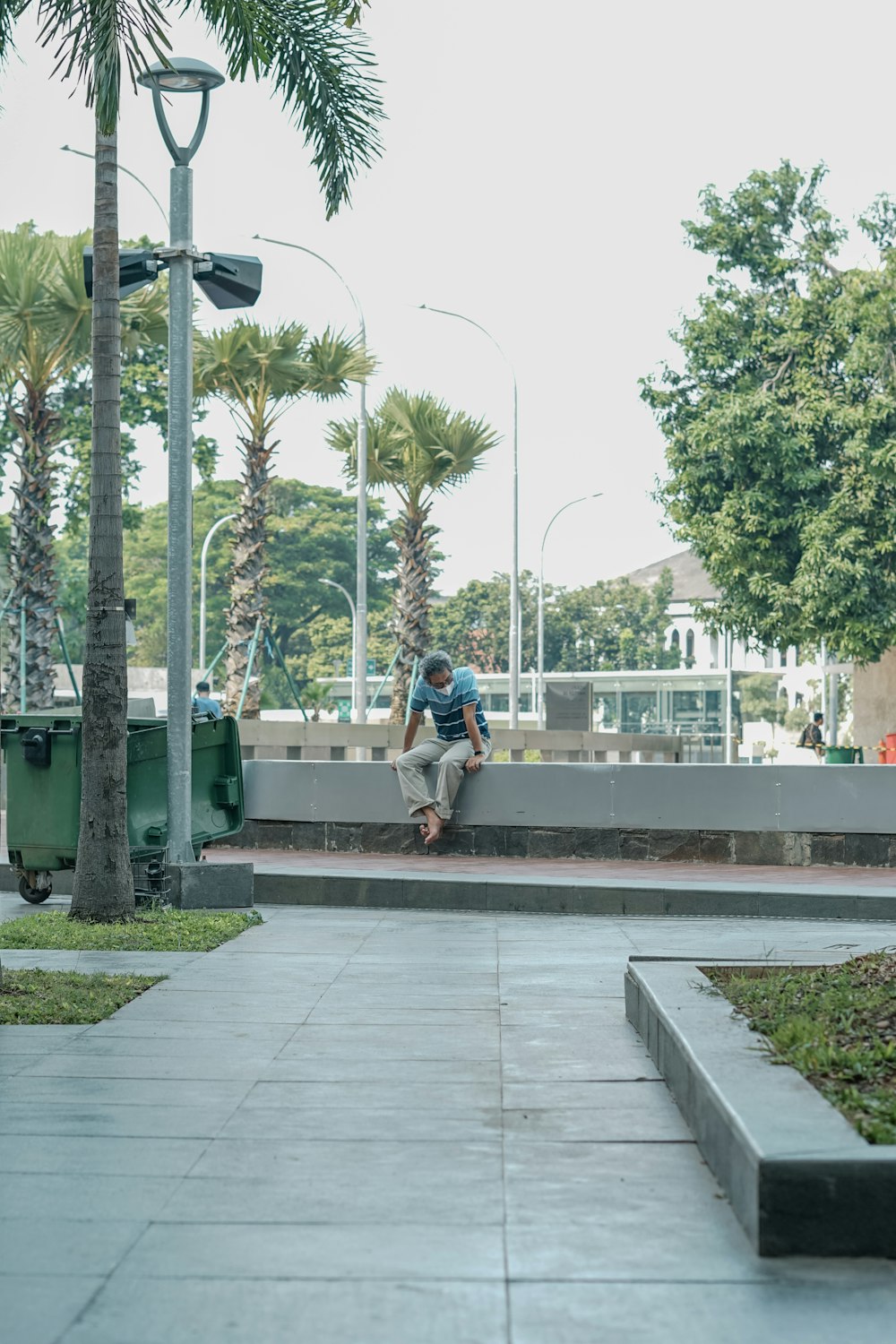 a man riding a skateboard down a sidewalk