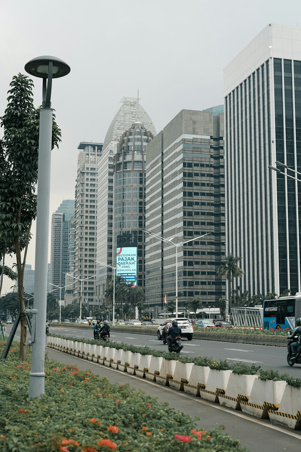 a busy city street with tall buildings in the background