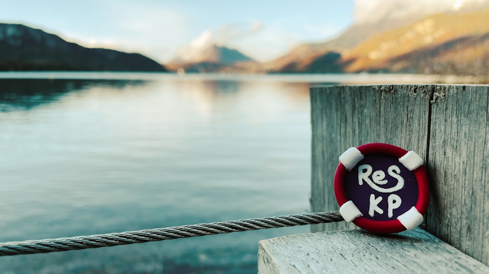 a red and white life preserver sitting on a dock