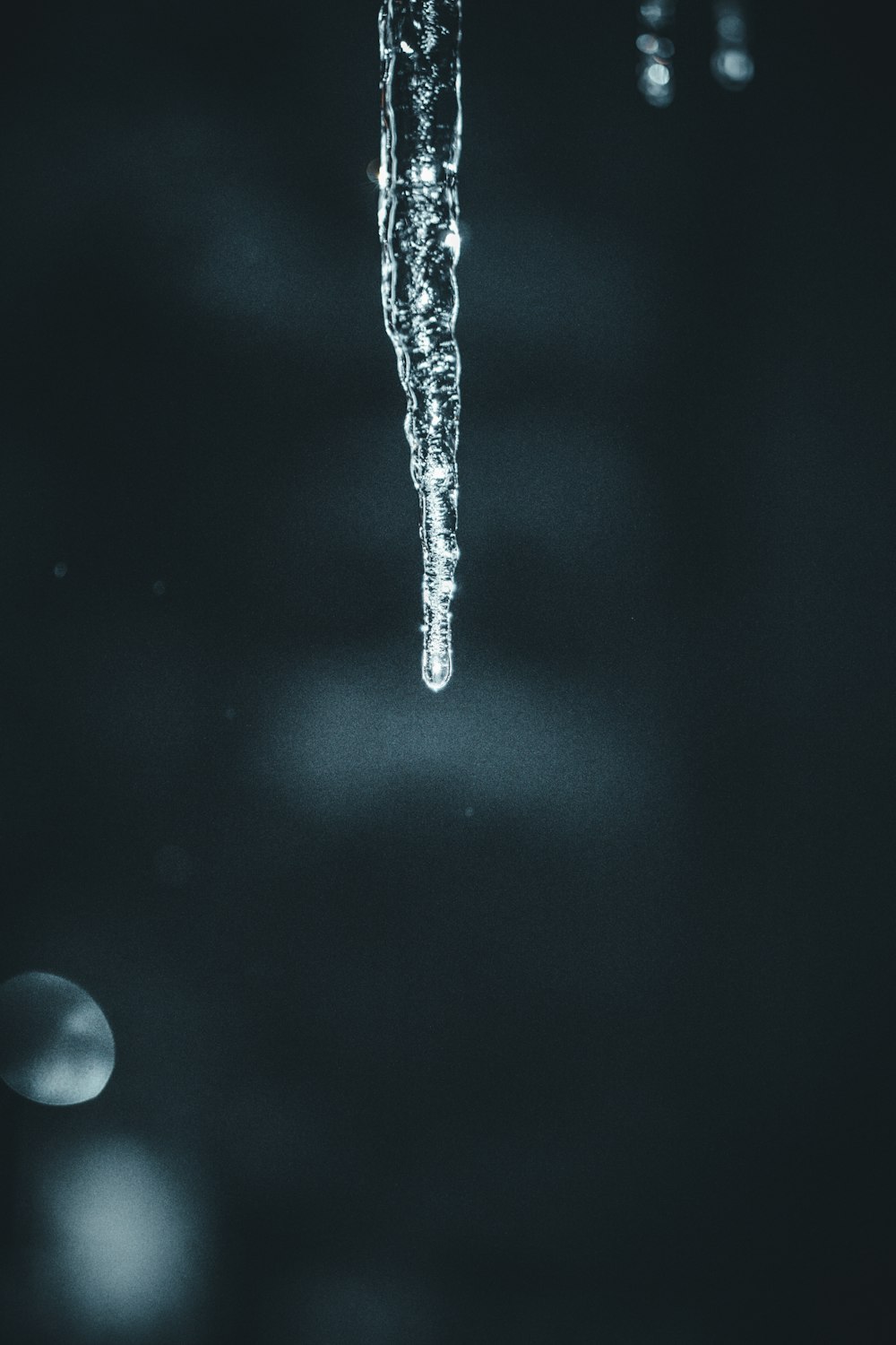 icicles hanging from the ceiling of a dark room