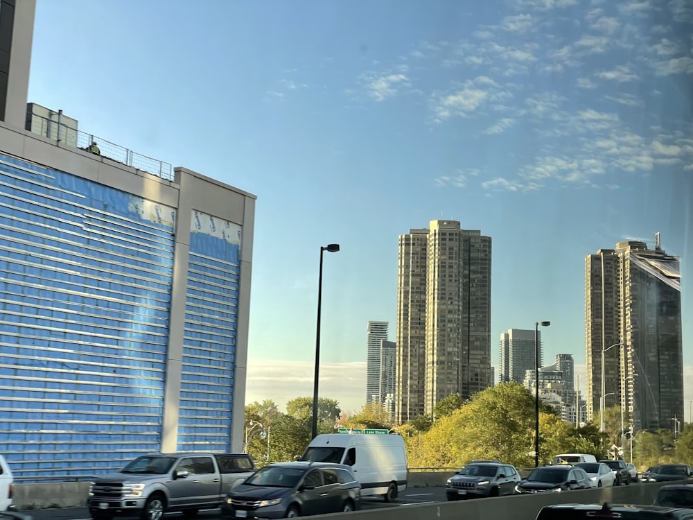 a city street filled with lots of traffic next to tall buildings