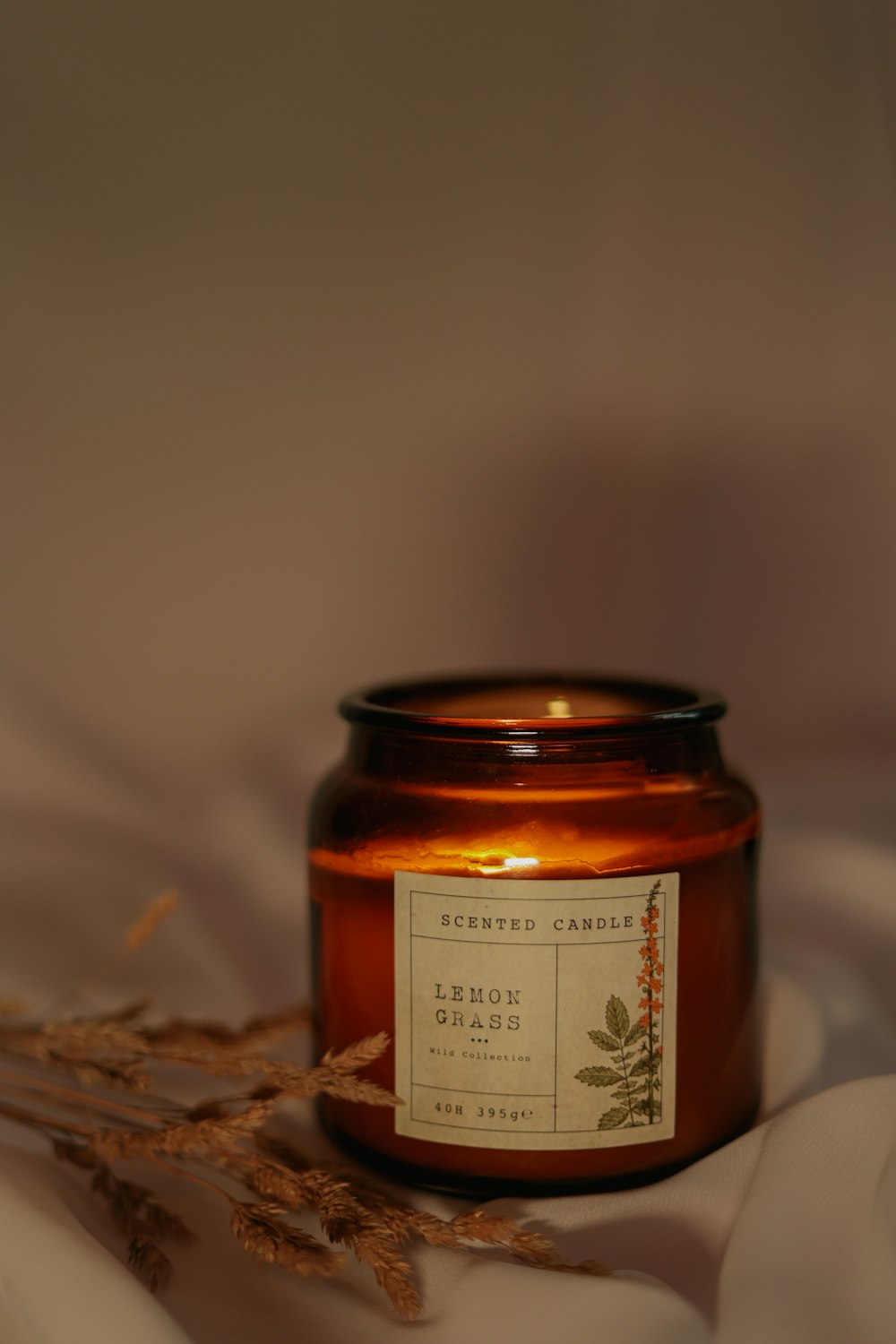 a candle is sitting on a white cloth