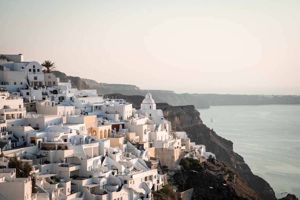 a view of a village on a cliff overlooking the ocean