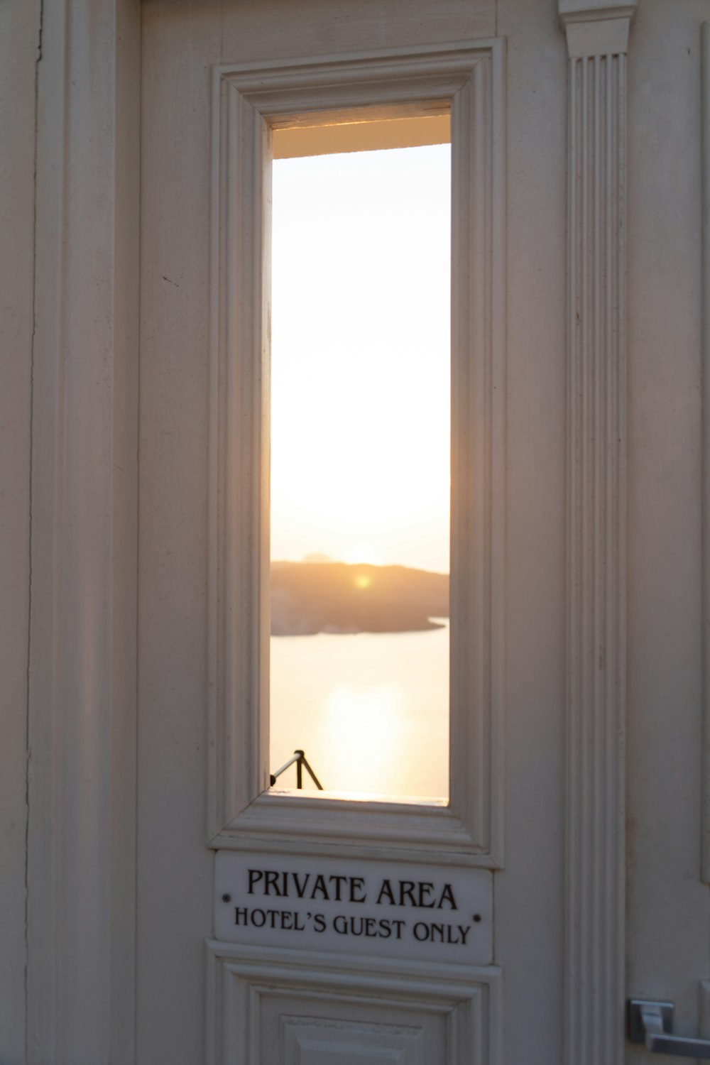 a white door with a sign that says private area hotel's guest only