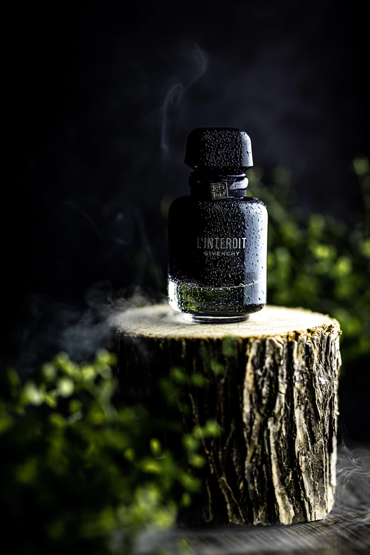 a bottle of alcohol sitting on top of a tree stump