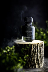 a bottle of alcohol sitting on top of a tree stump