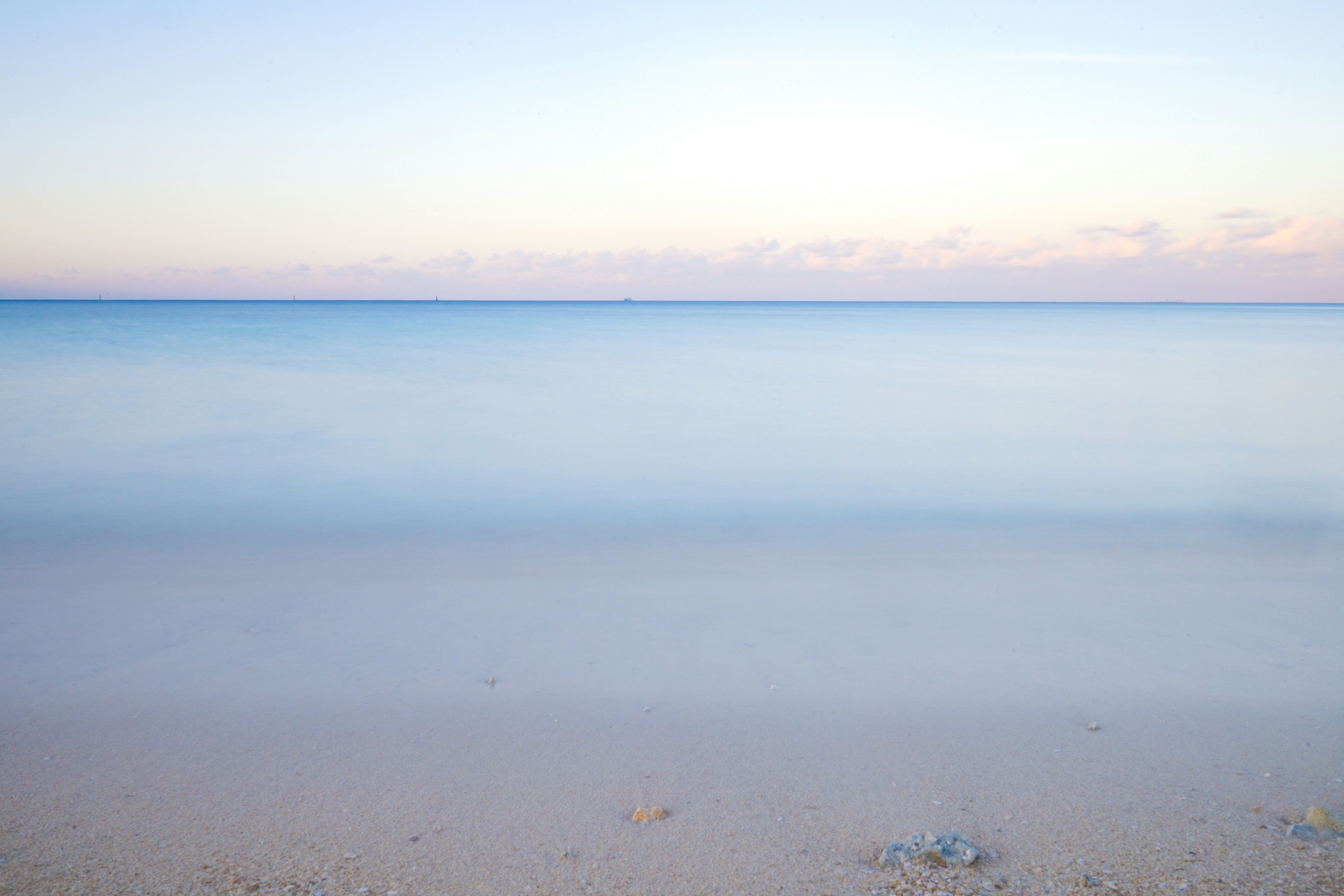 a view of the ocean from a sandy beach