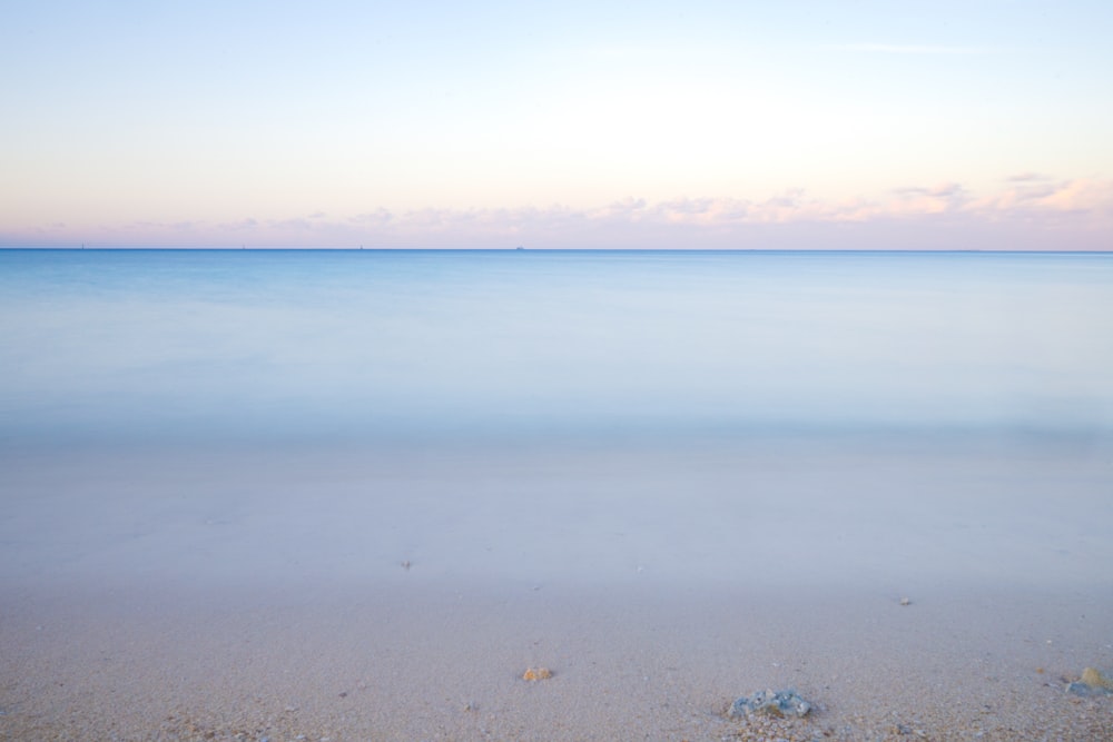 a view of the ocean from a sandy beach