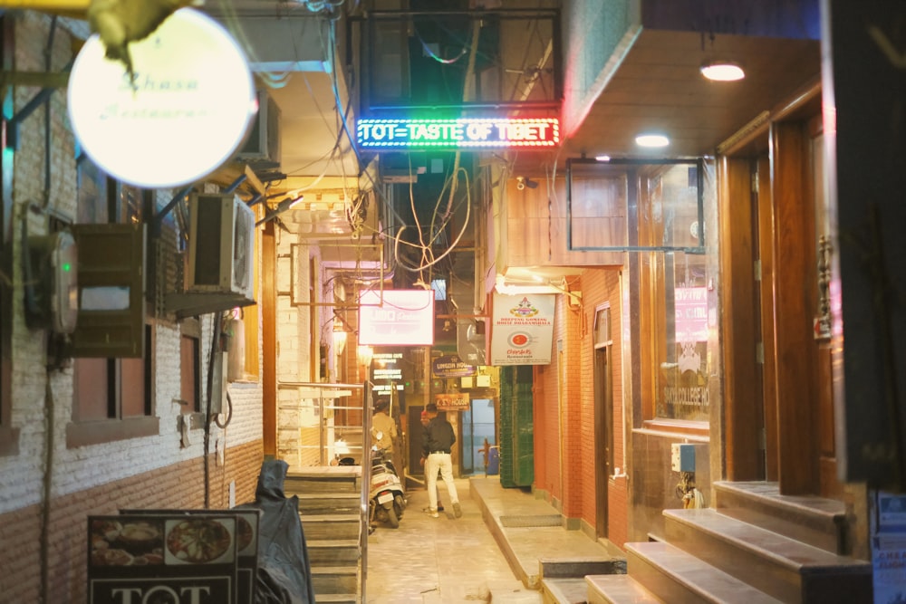 a man walking down a street next to a building