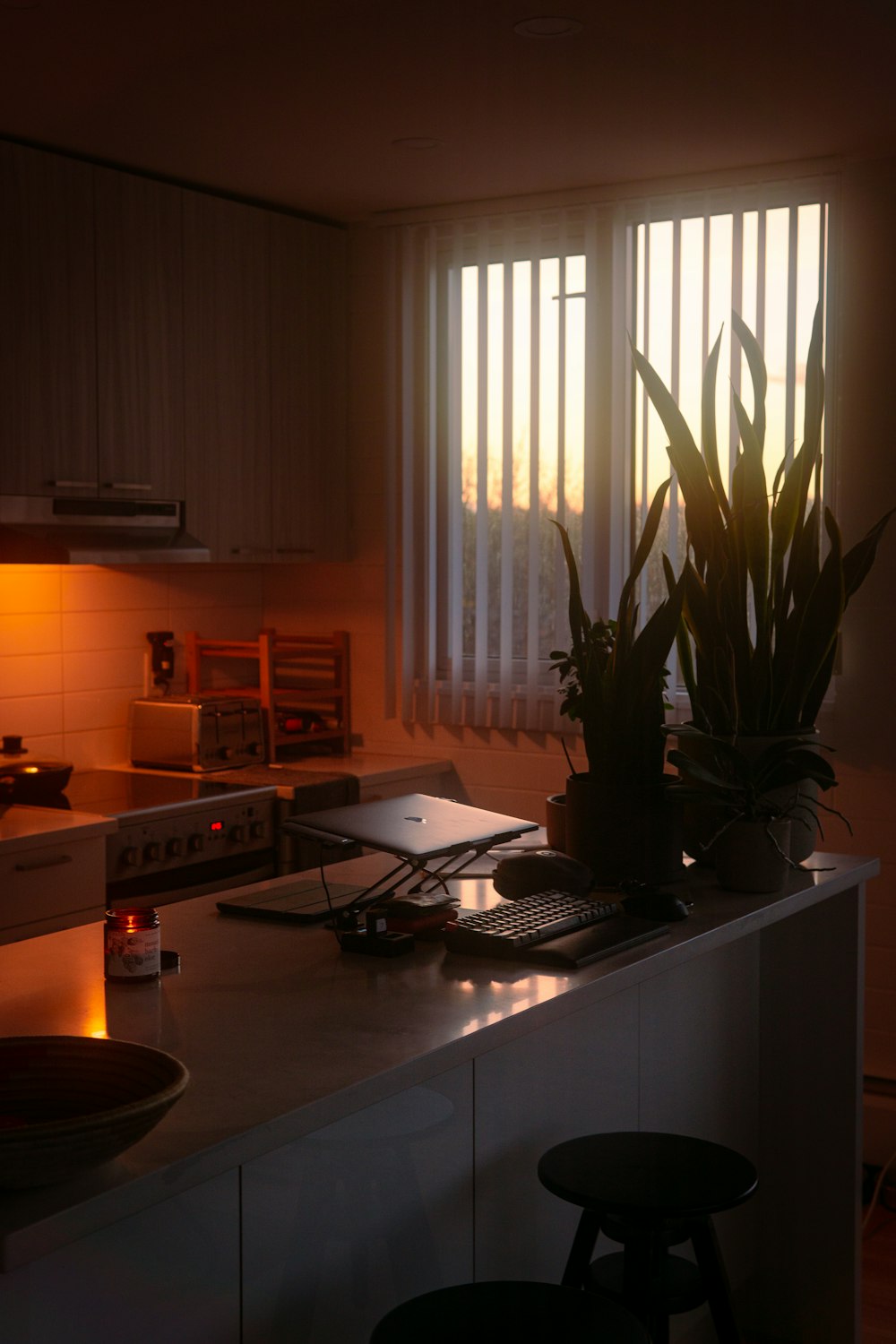 a kitchen with a stove top oven sitting next to a window