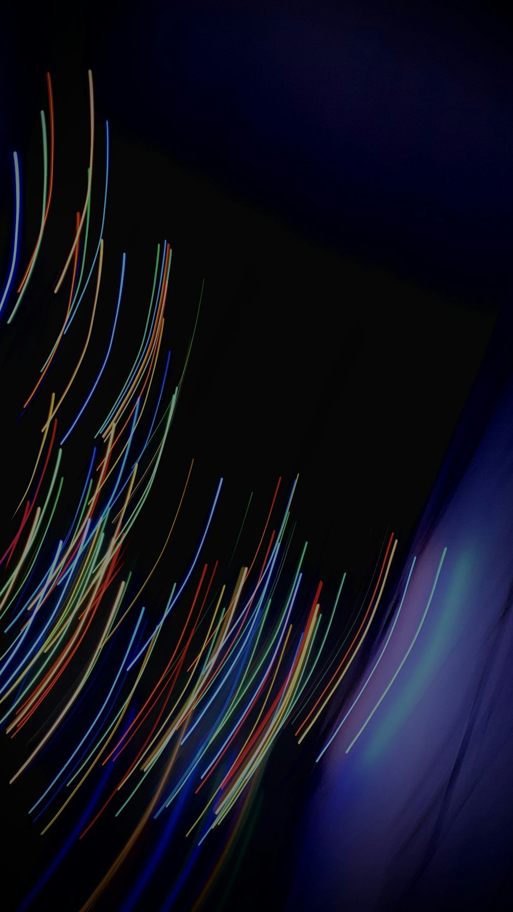 a blurry photo of colorful lines in the dark