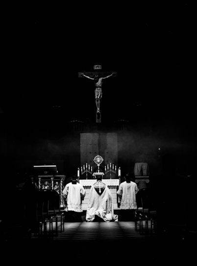 a black and white photo of a person sitting at a table in front of a