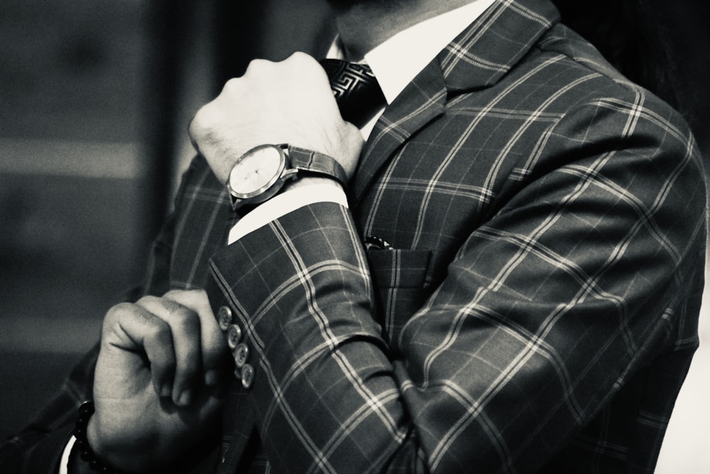 a man in a suit with a watch on his wrist