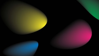 Abstract composition with overlapping blobs of light in various colors, including yellow, blue, pink, and green, set against a black background.