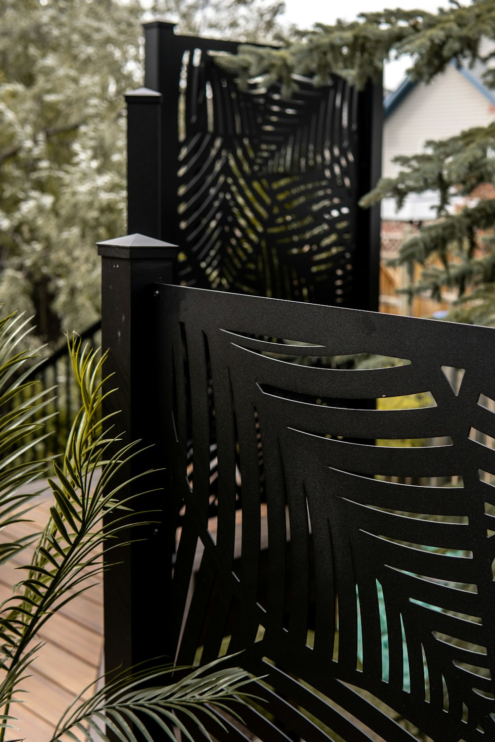 a metal bench sitting on top of a wooden deck