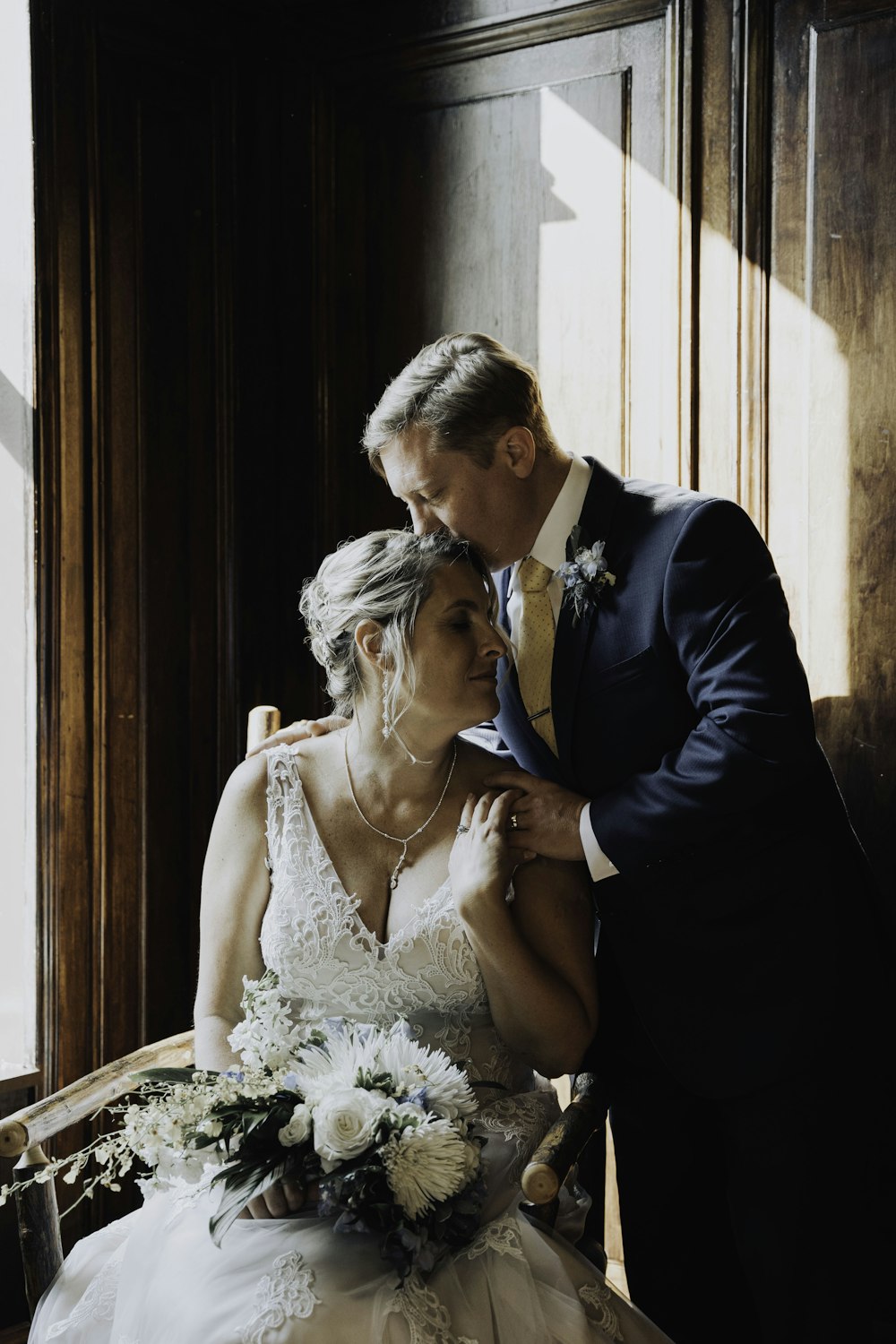 a bride and groom pose for a photo