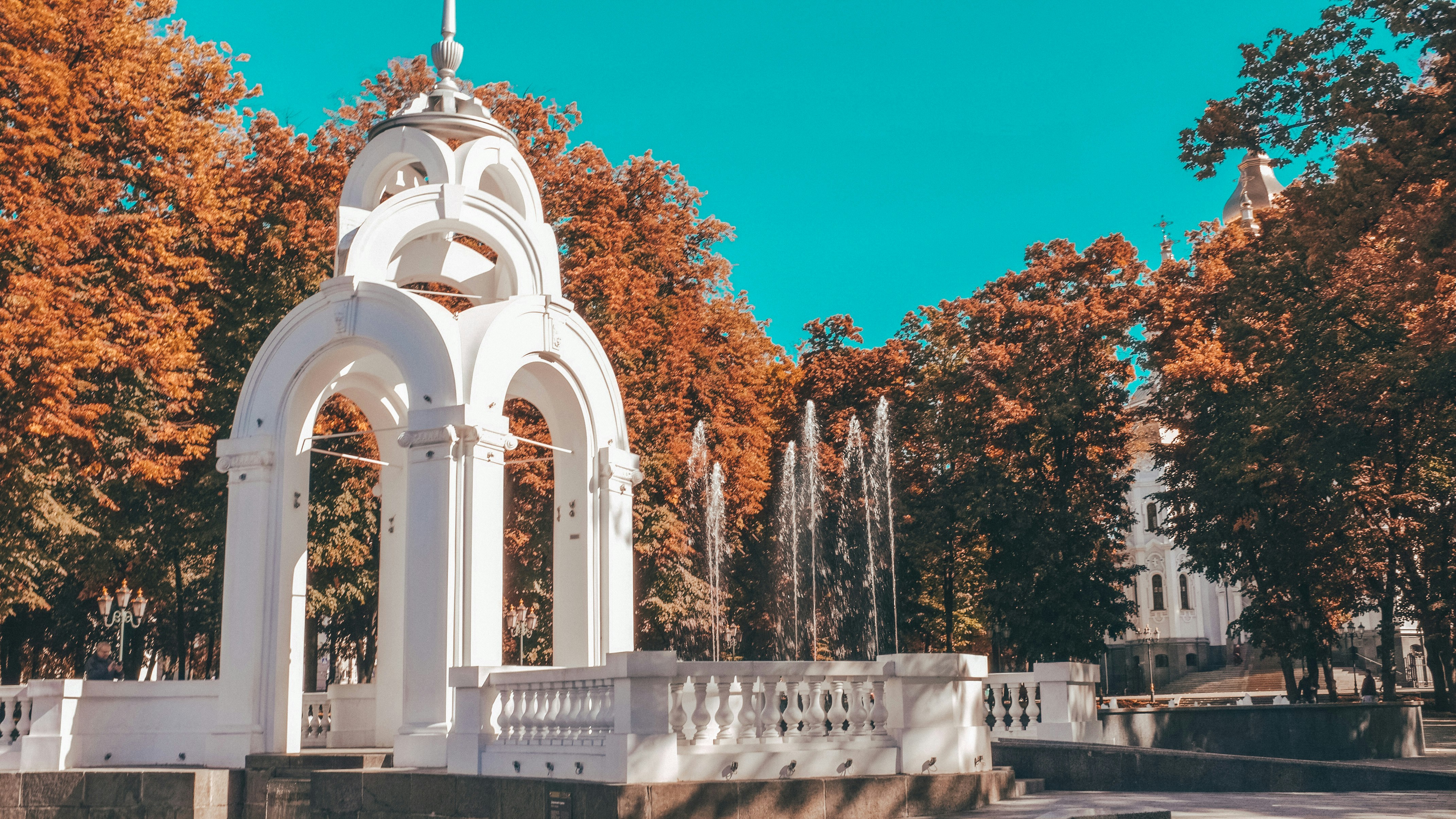 a white monument with a cross on top of it
