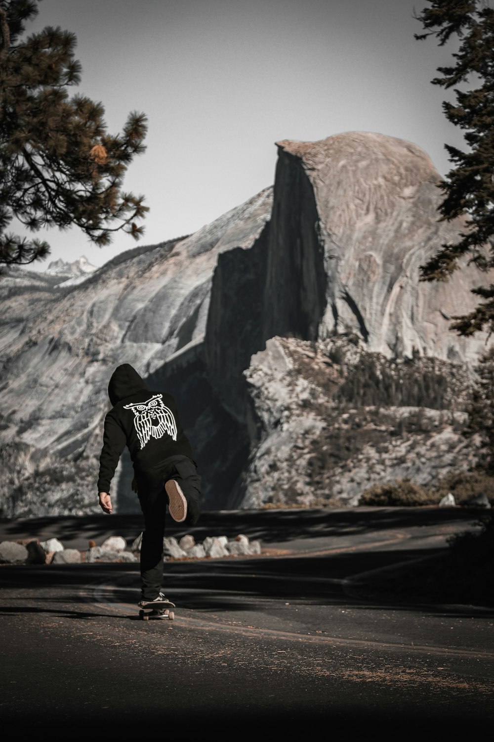 a man riding a skateboard down the side of a road