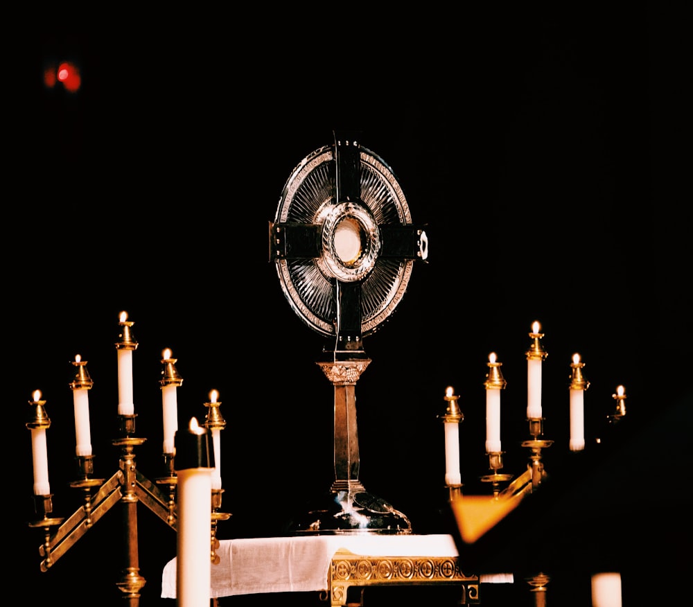a table with candles and a fan on it