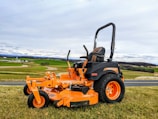 a lawn mower parked on the side of a road