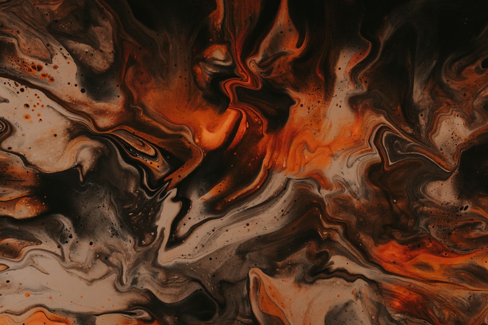 a close up of a black and orange abstract painting