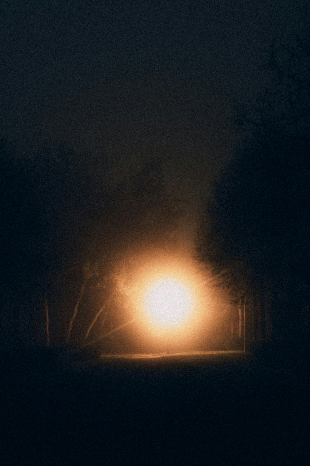 a street light in the middle of a dark road