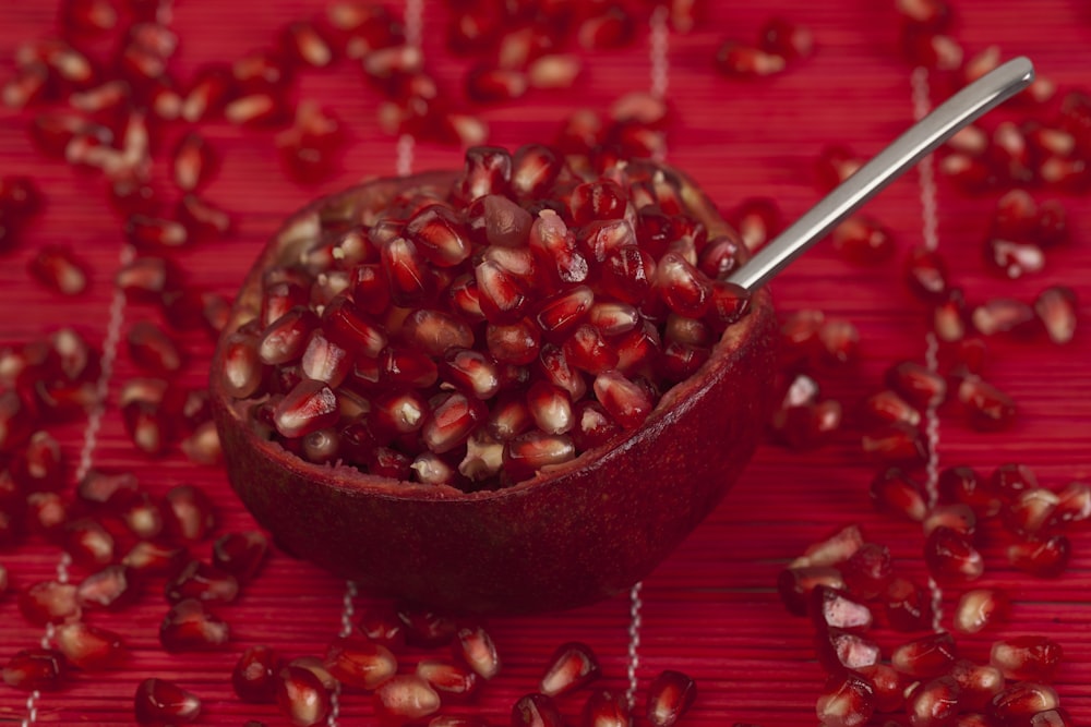 a bowl of pomegranate on a red table