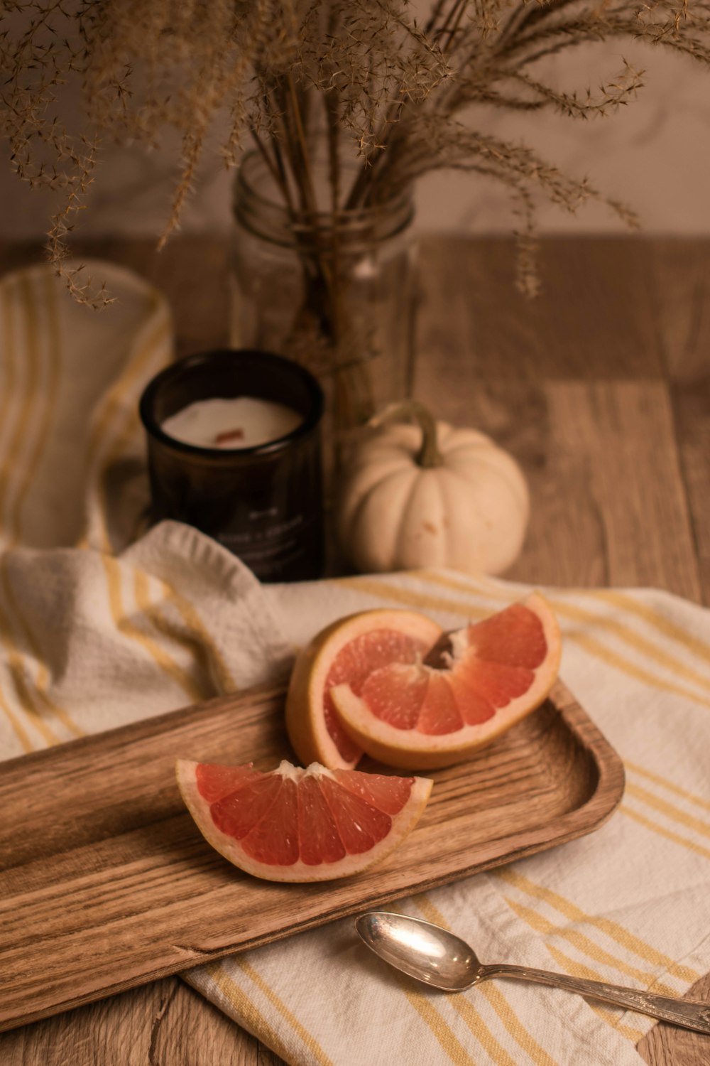 a wooden cutting board topped with sliced grapefruit