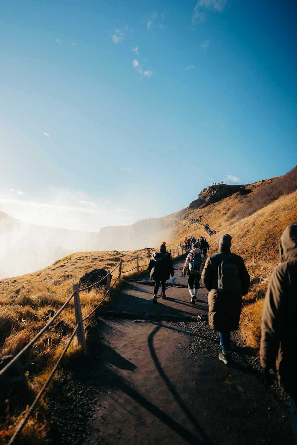 a group of people walking up a hill