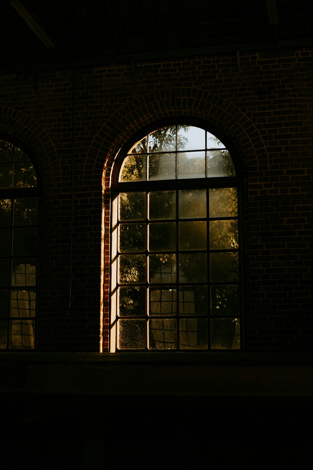 a brick building with two windows and a clock