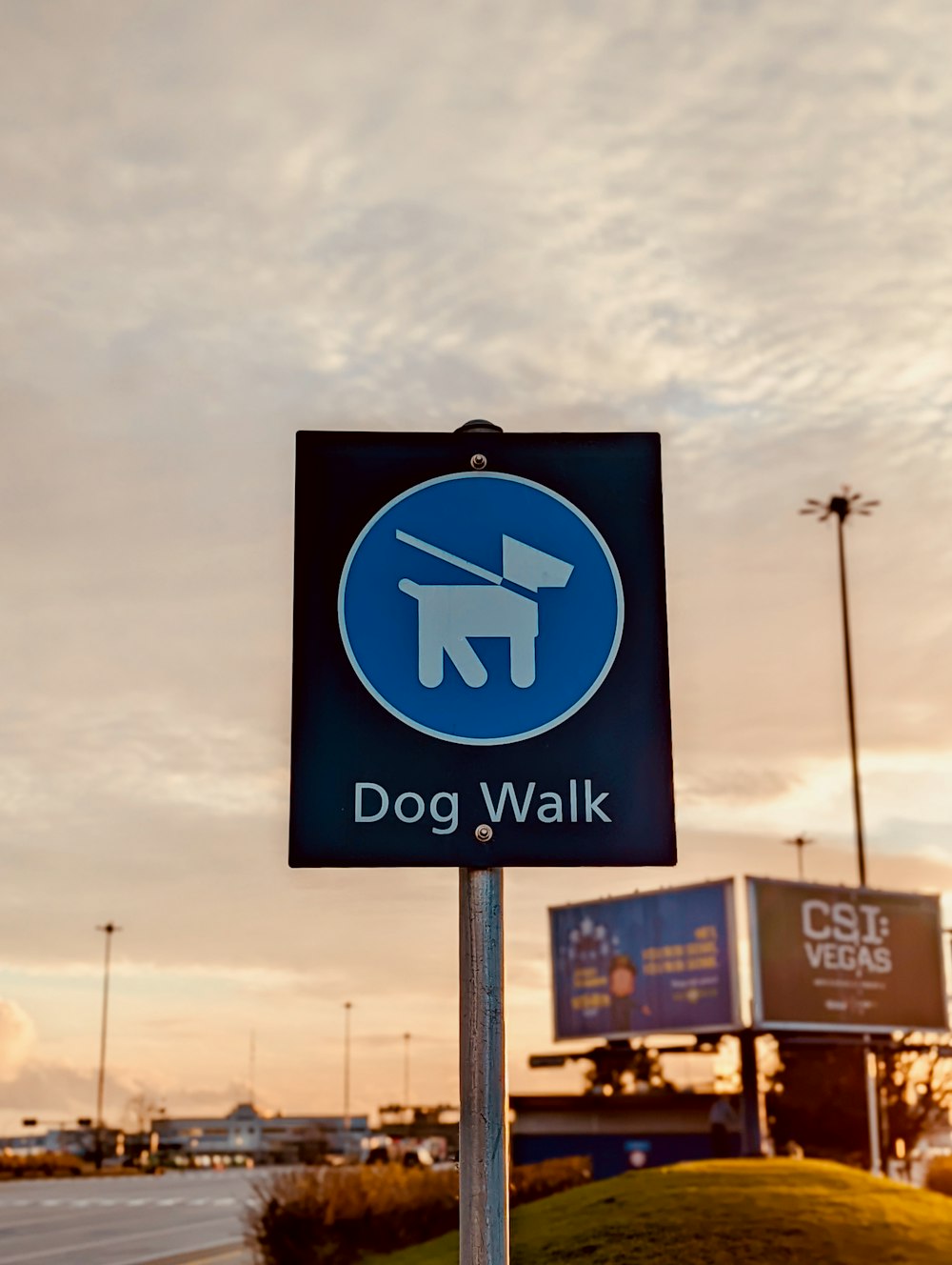 a dog walk sign in front of a building