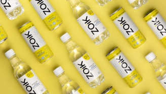 a group of bottles of water on a yellow background