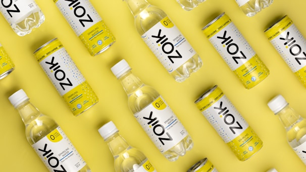 a group of bottles of water on a yellow background
