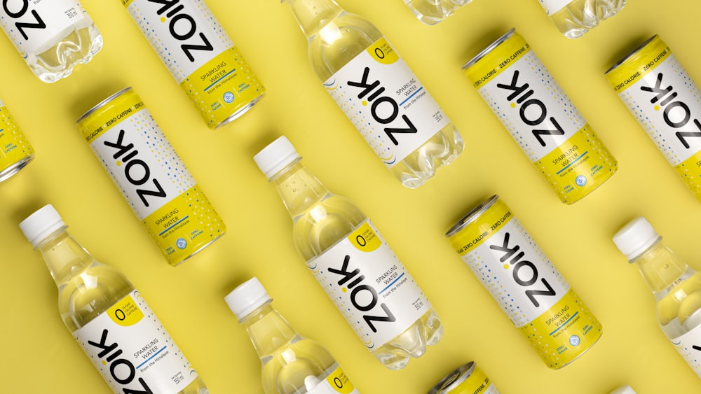 a group of bottles of water on a yellow background