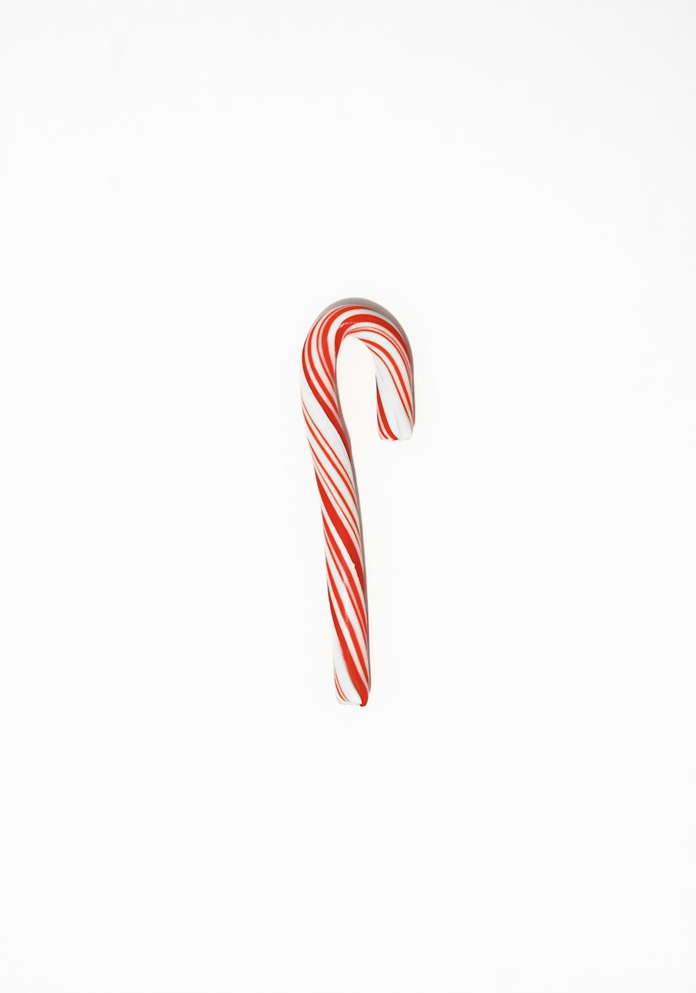 a red and white candy cane on a white background