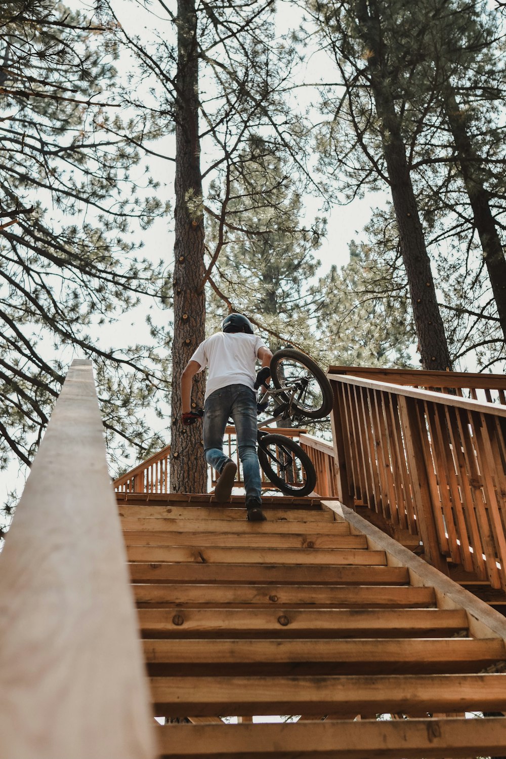 a man riding a bike down a wooden staircase