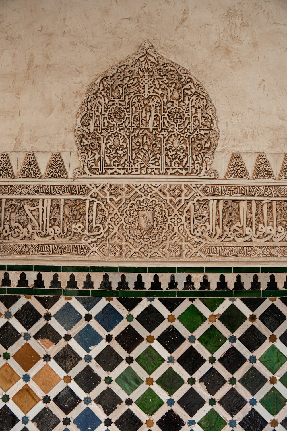 a close up of a tiled wall with a clock on it