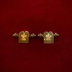 Elegant metal engraved keepsakes displayed on a rich velvet cloth, highlighting fine detail.