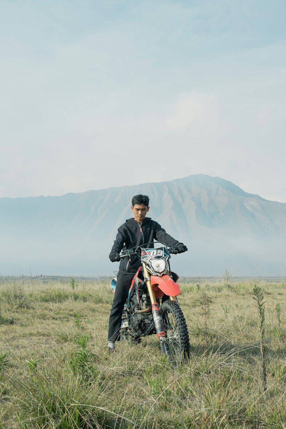 a man on a dirt bike in a field