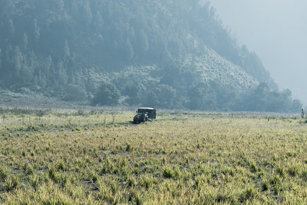 a truck is parked in the middle of a field