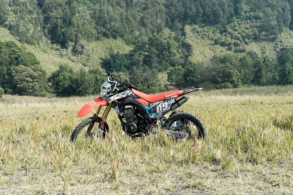 a dirt bike parked in a grassy field